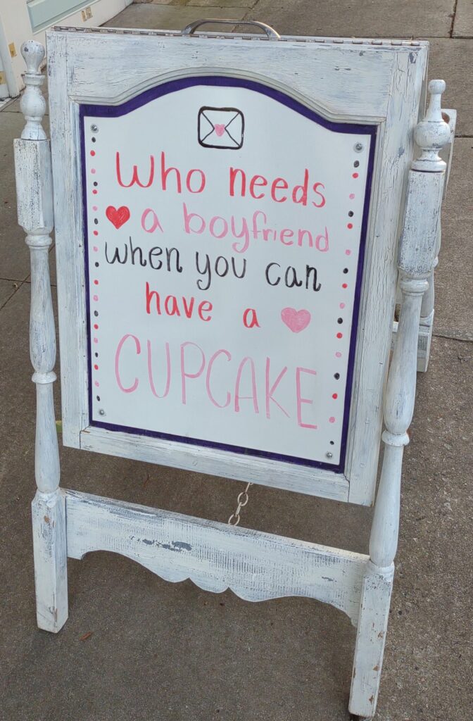 sign board reading Who needs a boyfriend when you can have a cupcake