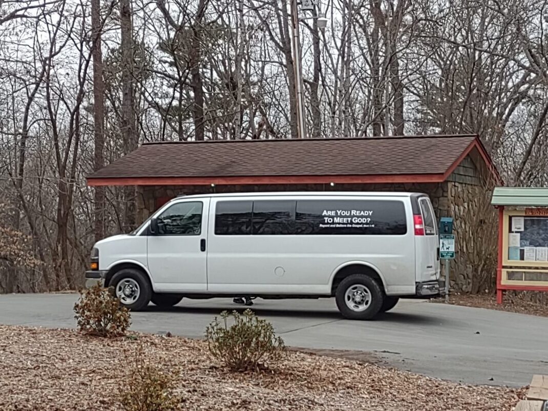 white van with religious fanatic message on window